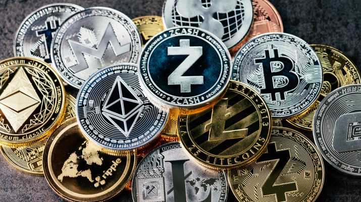 Crypto currency background with various of shiny silver and golden physical cryptocurrencies symbol coins, Bitcoin, Ethereum, Litecoin, zcash, ripple